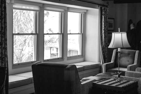 stock photo of two armchairs next to a large picture window