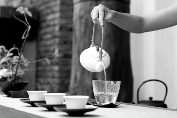 stock photo of a teapot pouring into cups